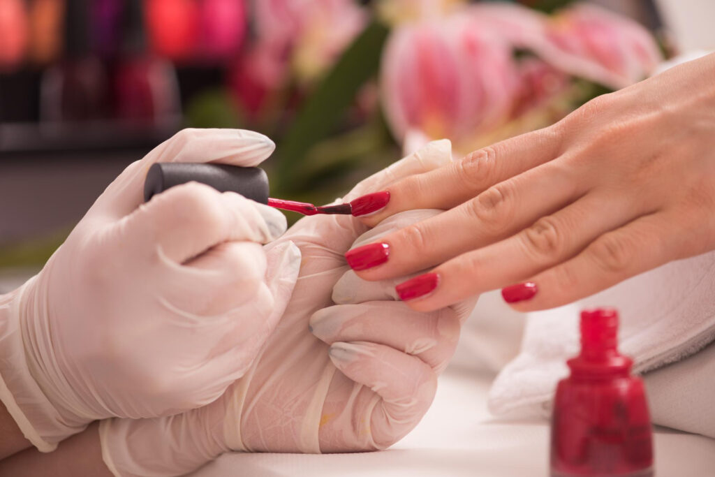 woman-hands-receiving-manicure-beauty-salon-nail-filing-close-up-selective-focus